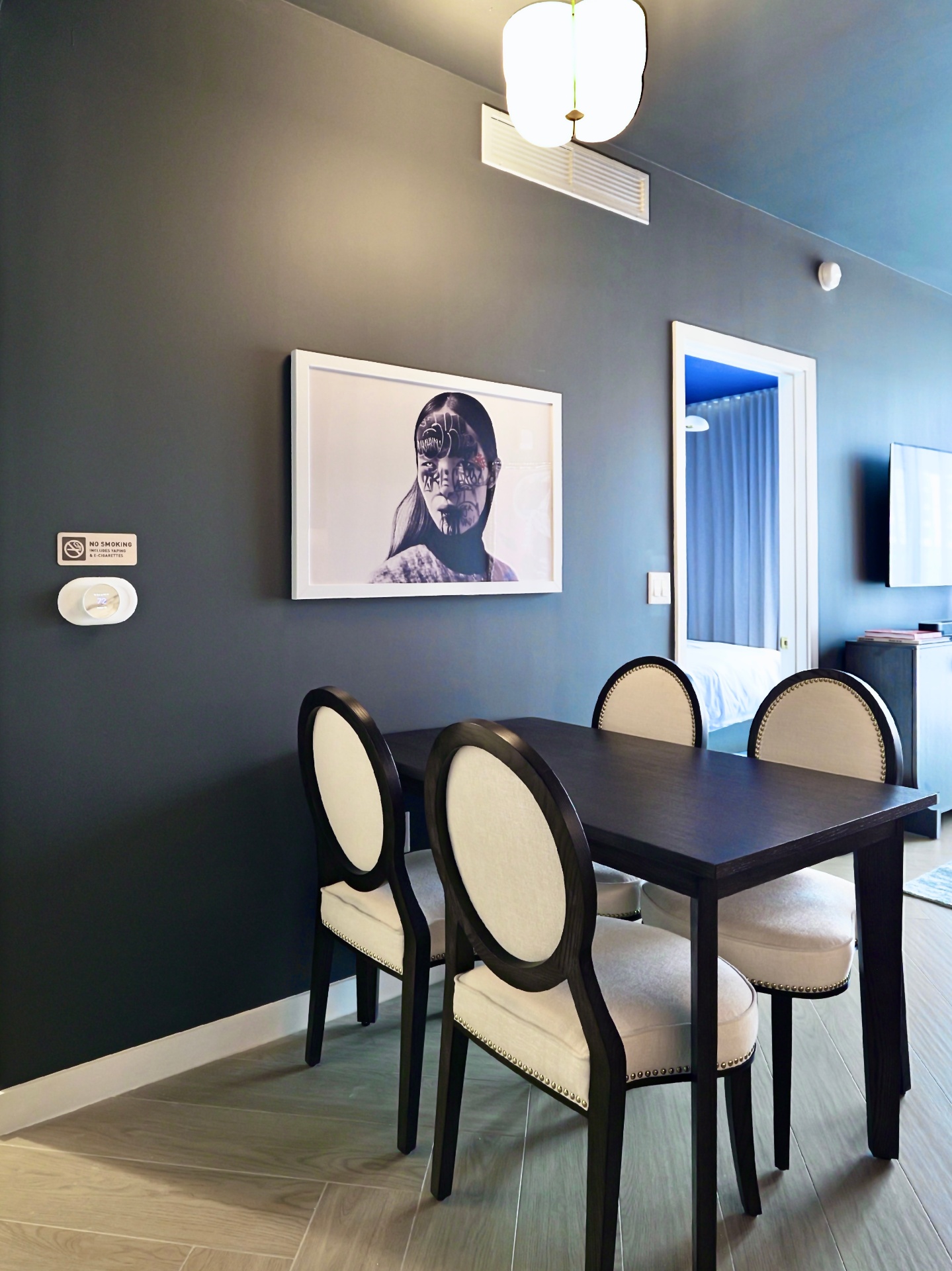 Dining area with framed contemporary photography