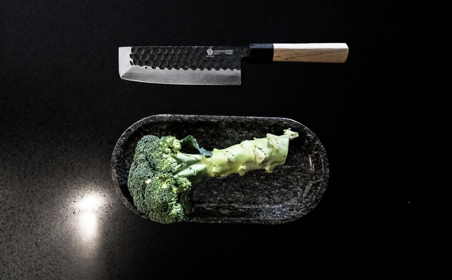 Japanese knife and fresh broccoli on the kitchen counter