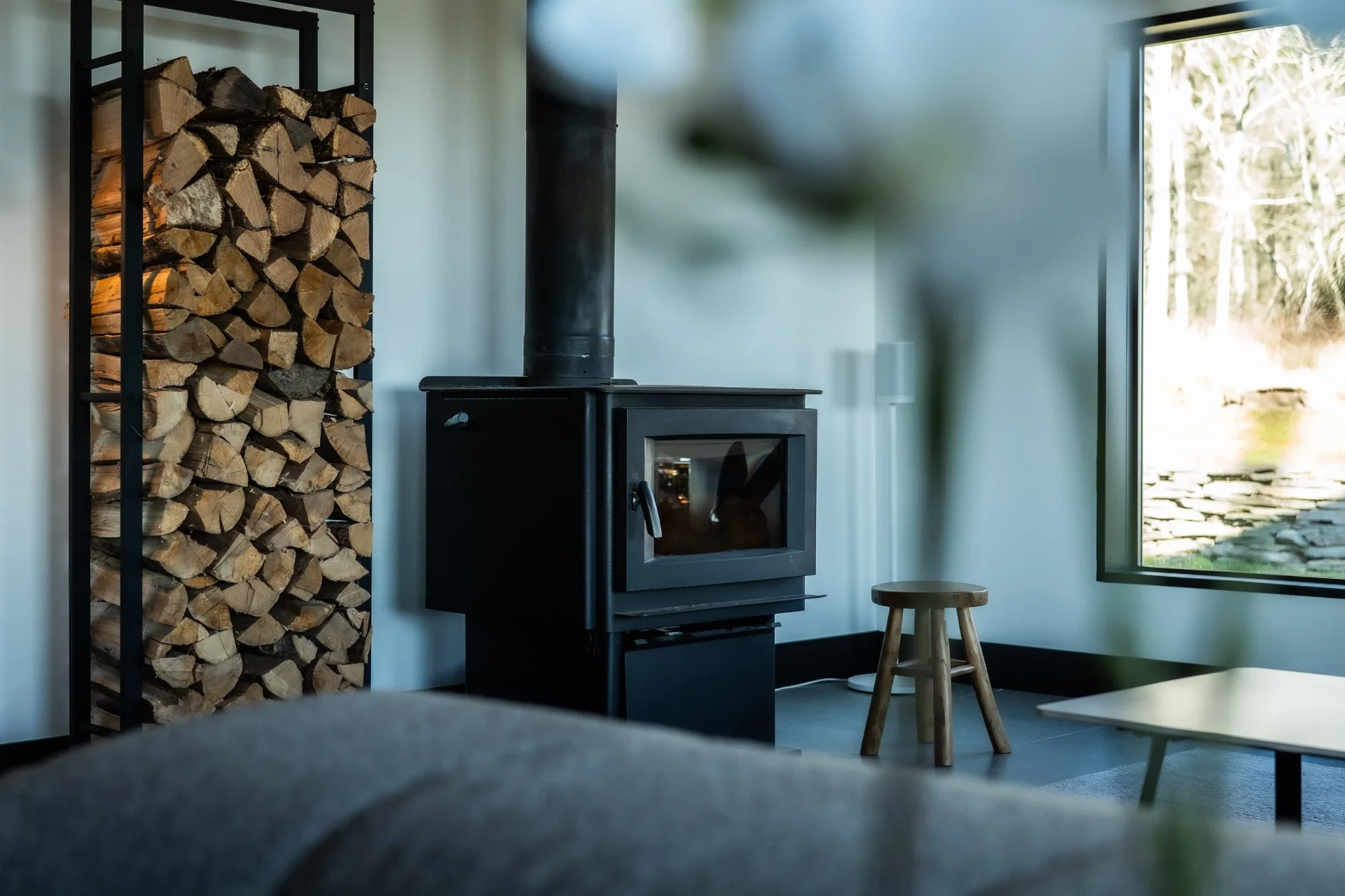 Wood-burning fireplace with stacked firewood