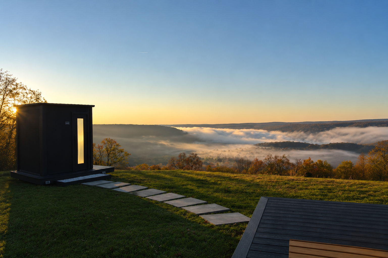 Outdoor cedar sauna at sunrise with fog rolling through the valley